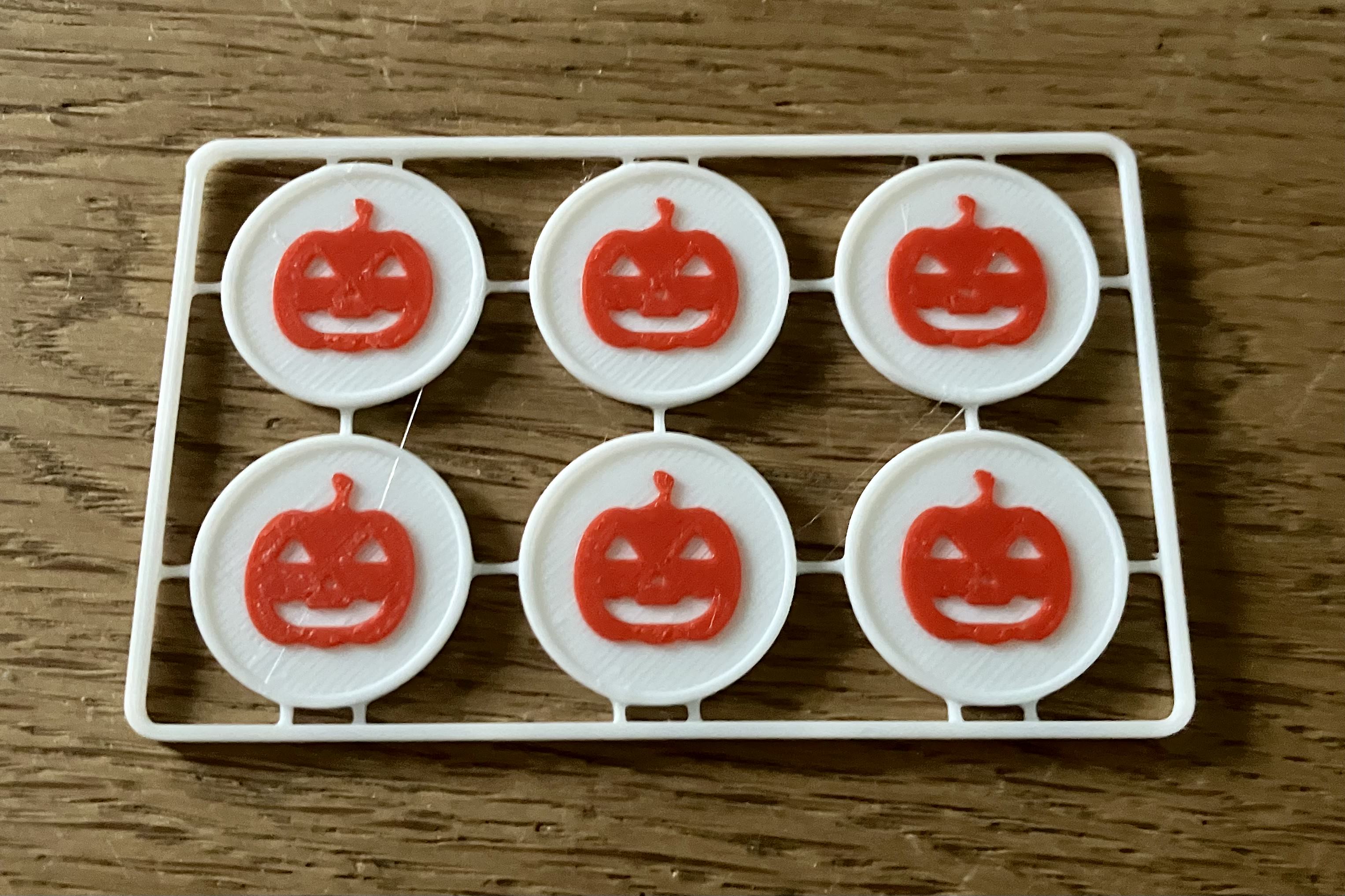 A series of white medallions with orange pumpkins