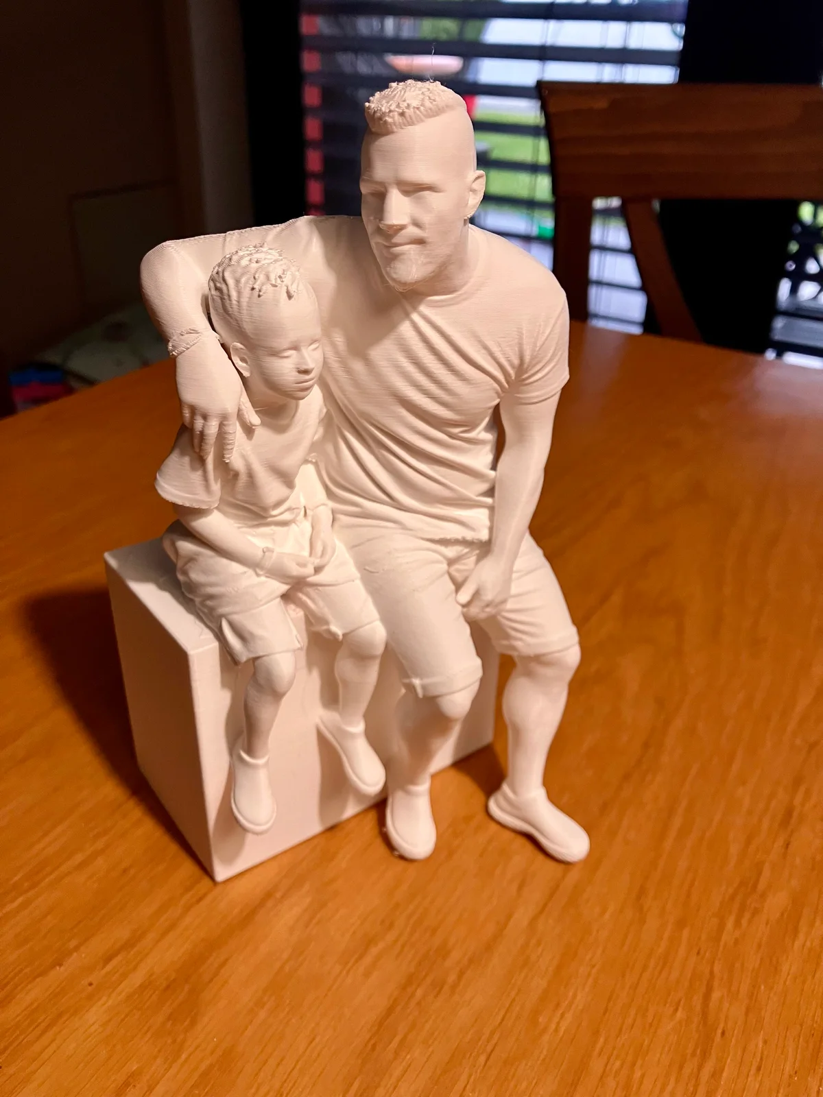 Family figurine on a table after the main supports have been removed