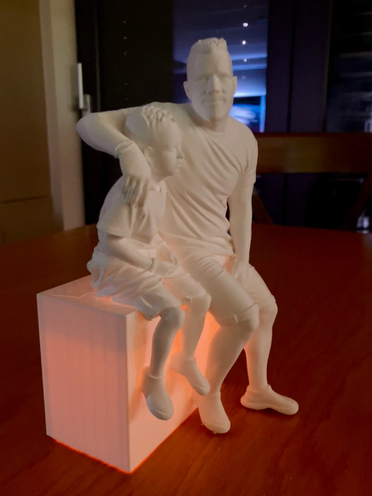 Front detail of the two faces on the family figurine