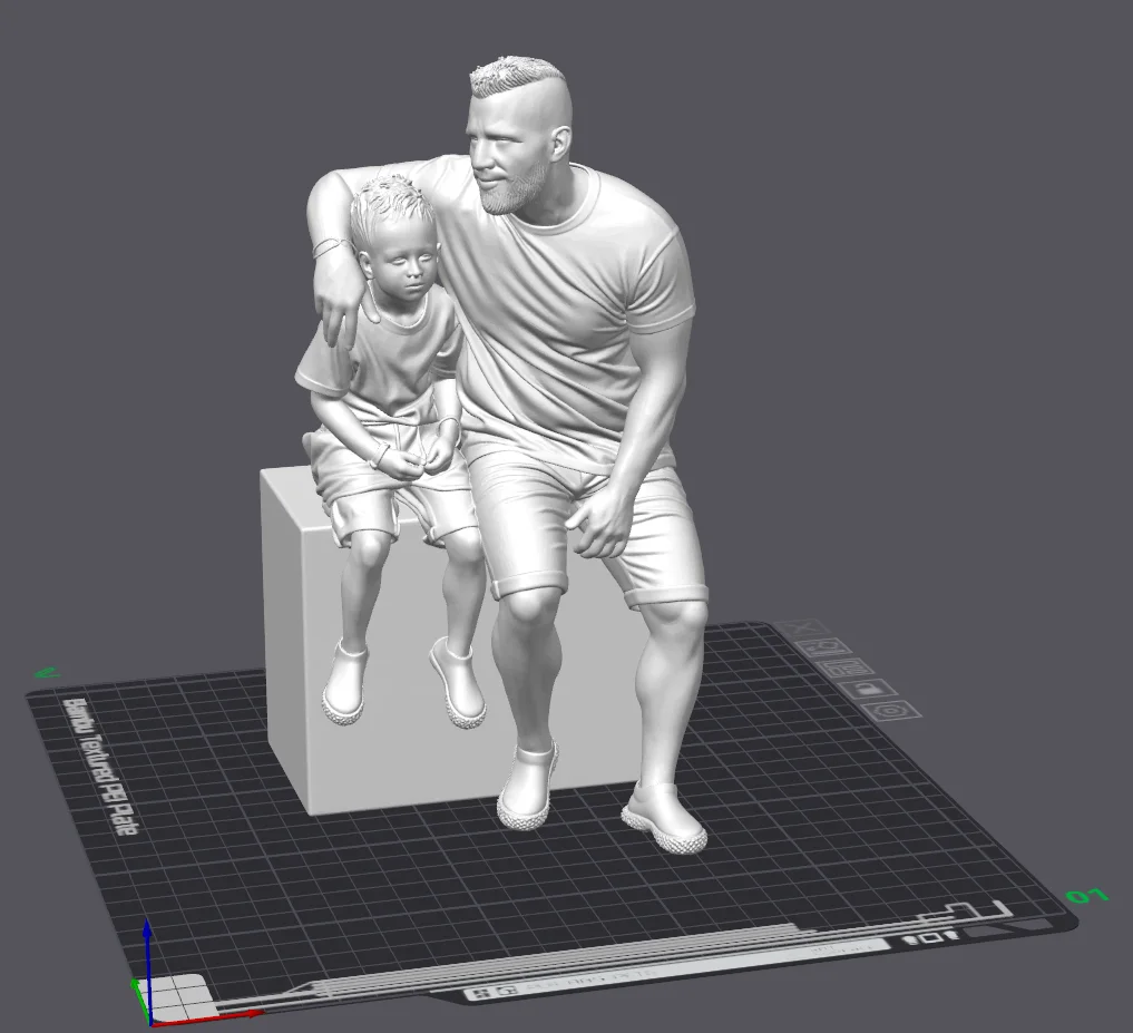 Digital model of two seated figures on a base in slicing software